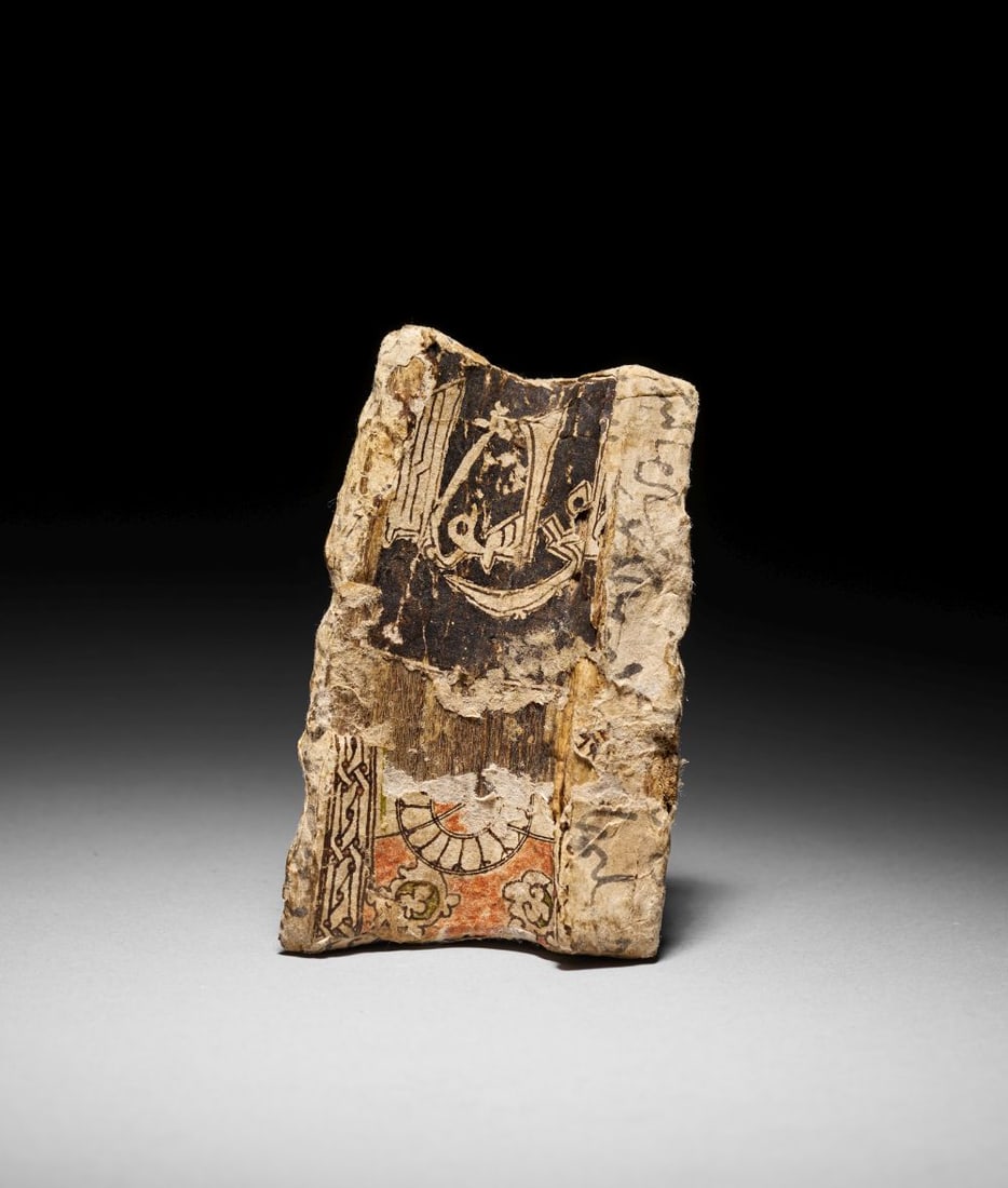 A FATIMID CARVED KUFIC INSCRIBED WOODEN PANEL FRAGMENT EGYPT, 11TH CENTURY (1 of 3)