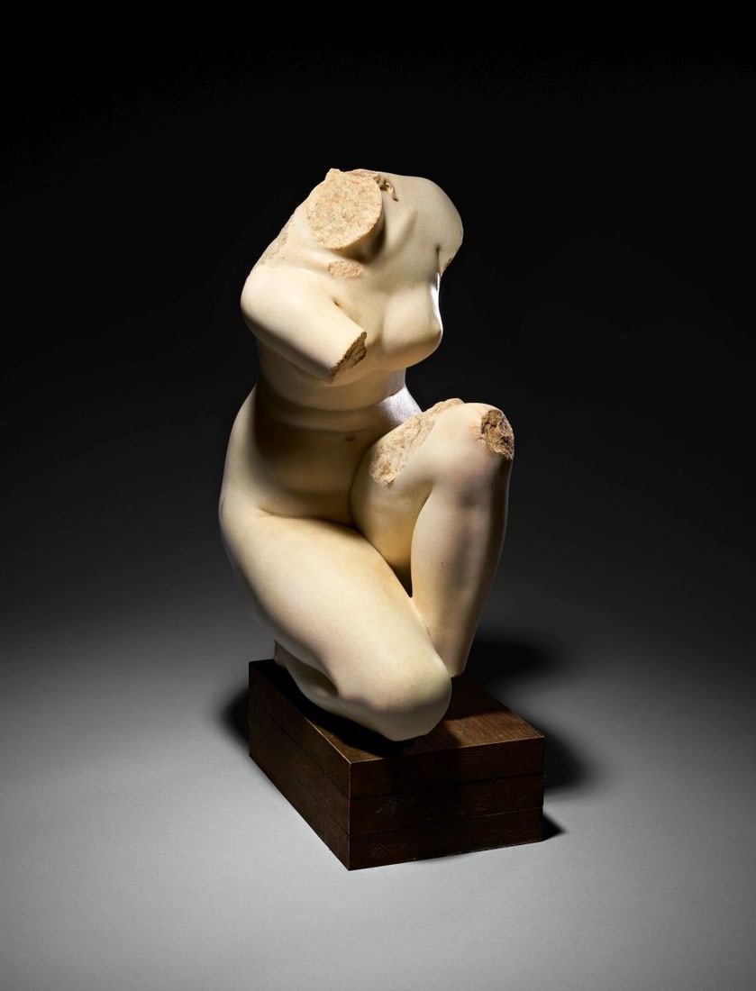 A ROMAN MARBLE TORSO OF A CROUCHING VENUS CIRCA 1ST-2ND CENTURY A.D.: A ROMAN MARBLE TORSO OF A CROUCHING VENUS, CIRCA 1ST–2ND CENTURY A.D. Carved from fine-grained pale marble, this compelling torso preserves the sinuous, compacted mass of a crouching female nu