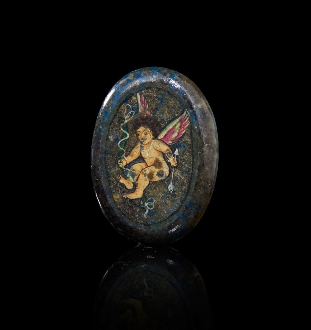 A LAPIS LAZULI BYZANTINE PLAQUE, DEPICTING A PAINTING OF A CUPID, CIRCA 7TH CENTURY A.D.: A LAPIS LAZULI BYZANTINE PLAQUE, DEPICTING A PAINTING OF A CUPID, CIRCA 7TH CENTURY A.D. Oval i