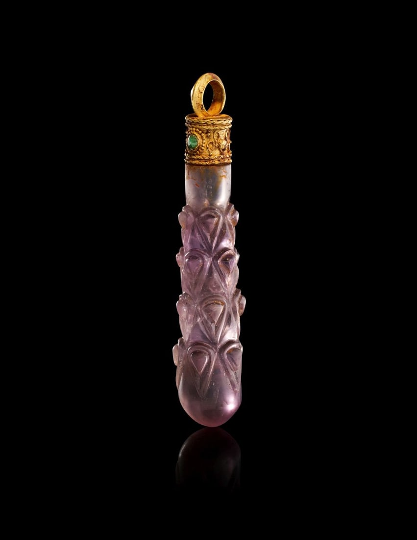 A ROMAN AMETHYST HERCULES CLUB AMULET PENDANT, CIRCA 2ND-3RD CENTURY A.D.: A ROMAN AMETHYST HERCULES CLUB AMULET PENDANT, CIRCA 2ND–3RD CENTURY A.D. Carved from richly translucent purple amethyst, this finely executed Roman amulet takes the distinctive form of the cl