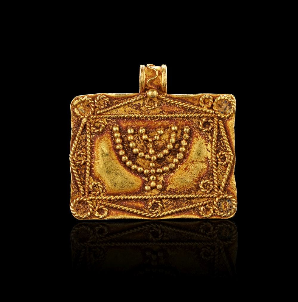 A ROMAN GOLD PENDANT WITH MENORAH DESIGN CIRCA: 1ST-3RD CENTURY A.D. (1 of 2)