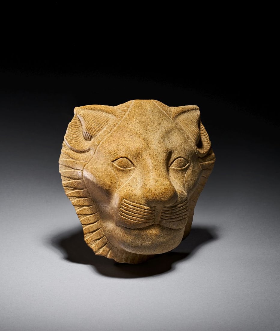 AN EGYPTIAN HARDSTONE HEAD OF SEKHMET THEBES, NEW KINGDOM, 18TH DYNASTY, REIGN OF AMENHOTEP III, C: AN EGYPTIAN HARDSTONE HEAD OF SEKHMET THEBES, NEW KINGDOM, 18TH DYNASTY, REIGN OF AMENHOTEP III, CIRCA 1388–1351 B.C. Carved in fine-grained hardstone of warm buff-brown colour wit