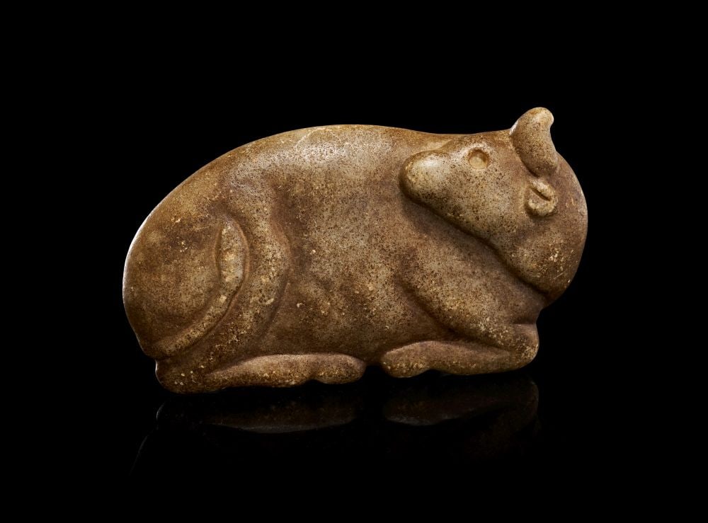 EGYPTIAN MARBLE FIGURINE OF A RECUMBENT COW, LATE PERIOD, CIRCA 700-300 B.C. (1 of 2)