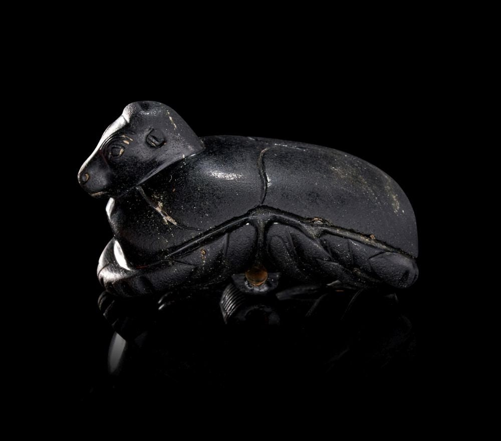 AN EGYPTIAN FUNERY BULL HEADED HEART SCARAB, LATE PERIOD - EARLY PTOLEMAIC PERIOD, CIRCA 7TH-3RD CEN:  AN EGYPTIAN FUNERARY BULL-HEADED HEART SCARAB LATE PERIOD – EARLY PTOLEMAIC PERIOD, CIRCA 7TH–3RD CENTURY B.C. Carved from dark igneous stone of deep black tone with a