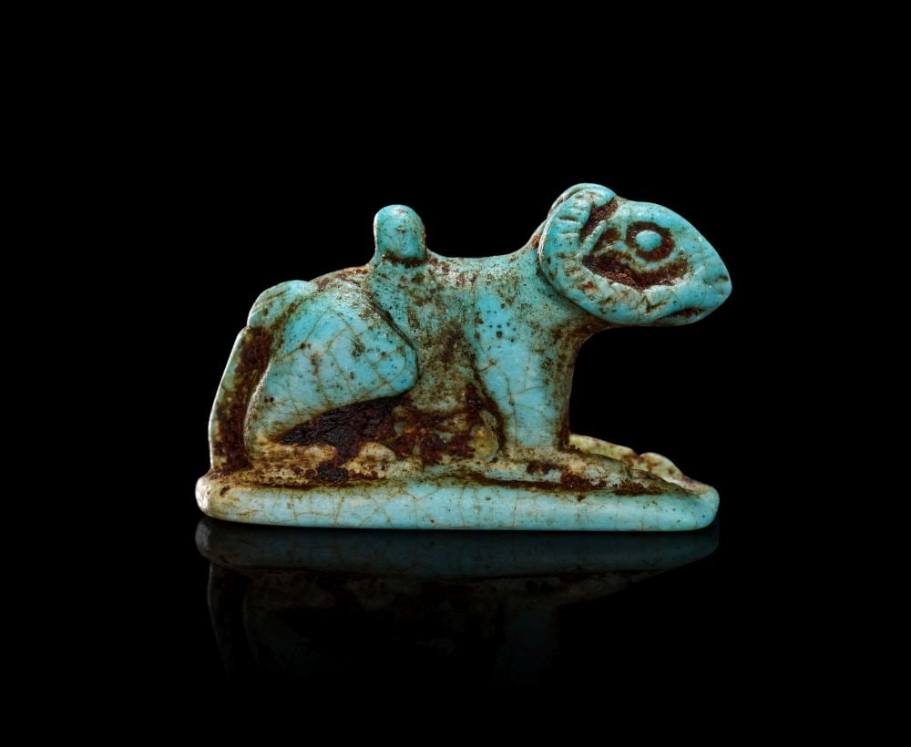 AN EGYPTIAN FAIENCE AMULET OF AMUN LATE PERIOD, DYNASTY XXVI-XXX, 664-343 B.C. (1 of 2)