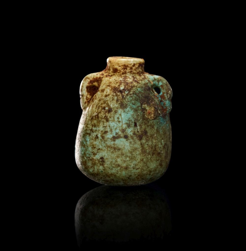 AN EGYPTIAN FAIENCE AMULET OF A KOHL POT LATE PERIOD, DYNASTY XXVI-XXX, 664-343 B.C. (1 of 2)