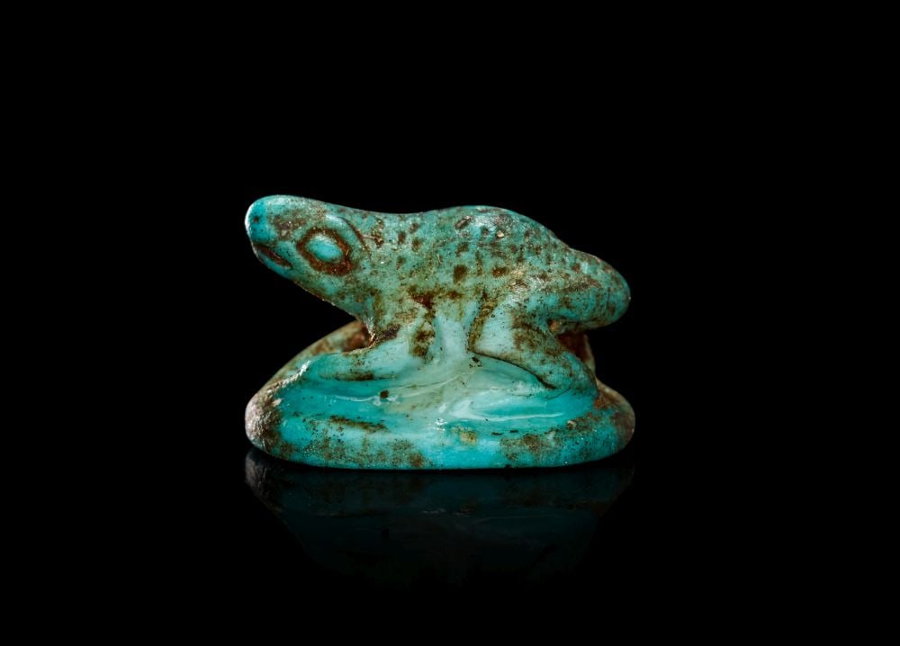 AN EGYPTIAN TURQUOISE GLAZED COMPOSITION FROG NEW KINGDOM, CIRCA 1550-1069 B.C. (1 of 2)