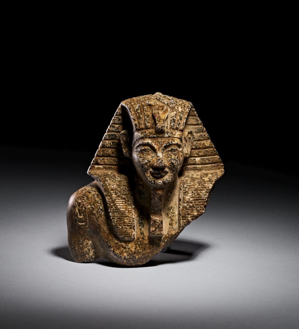 AN EGYPTIAN GRANITE HEAD OF A ROYAL OFFICIAL NEW KINGDOM, REIGN OF AMENOPHIS III, 1391-1351 B.C. (1 of 5)