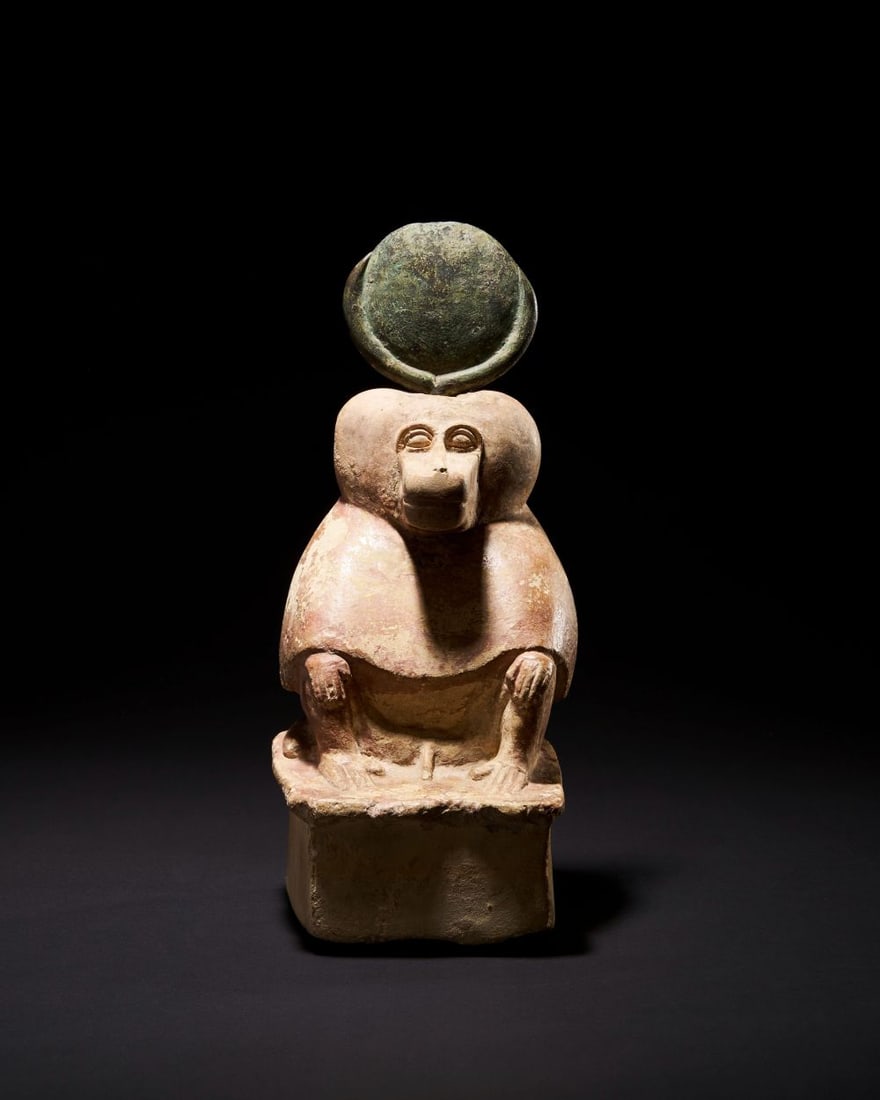 AN EGYPTIAN BABOON STATUETTE OF THE GOD THOTH, LATE PERIOD, CIRCA 664-323 B.C.: AN EGYPTIAN BABOON STATUETTE OF THE GOD THOTH, LATE PERIOD, CIRCA 664-323 B.C. Carved from a pa