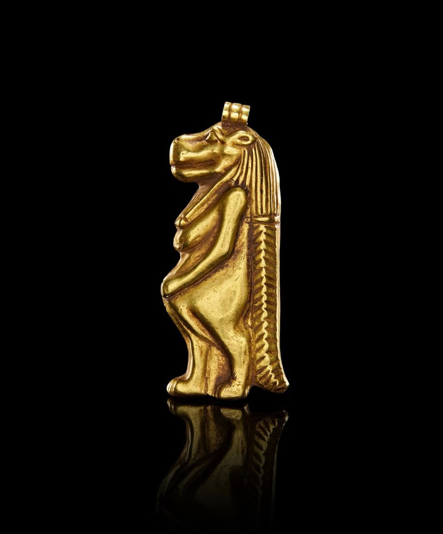 AN EGYPTIAN GOLD TAWERET AMULET, PTOLEMAIC PERIOD, CIRCA 323–30 B.C.: AN EGYPTIAN GOLD TAWERET AMULET, PTOLEMAIC PERIOD, CIRCA 323–30 B.C. Cast in solid gold, this