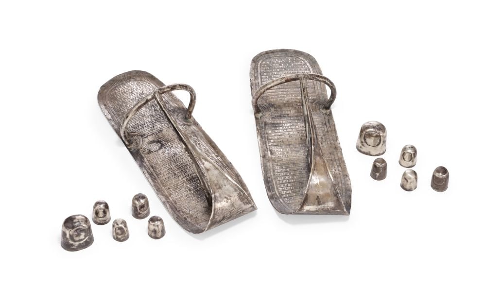 A PAIR OF EGYPTIAN SILVER SANDALS WITH TOE CAPS, NEW KINGDOM, CIRCA 1550-1069 B.C.: A PAIR OF EGYPTIAN SILVER SANDALS WITH TOE CAPS, NEW KINGDOM, CIRCA 1550–1069 B.C. Hammered from thin sheets of silver, the pair presents with a striking, elongated silhouette, the soles taper