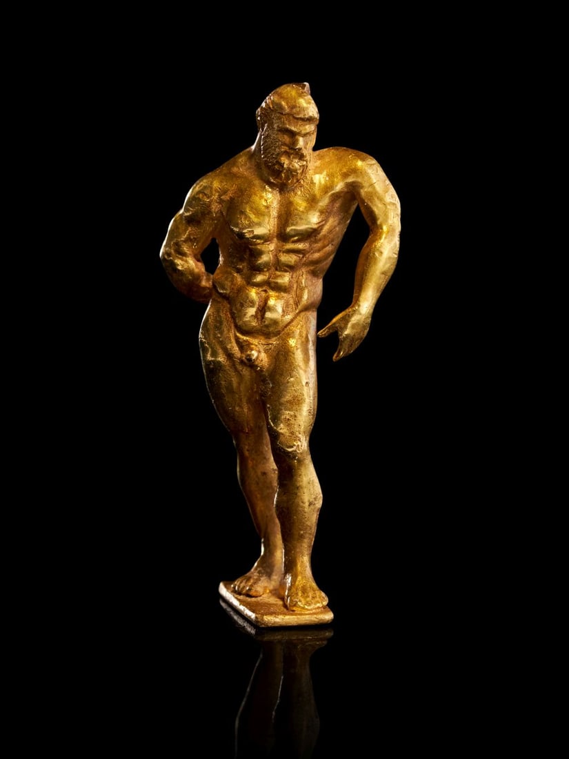 A GREEK GOLD FIGURINE OF THE FARNESE HERCULES SCULPTURE, CIRCA 3RD-4TH CENTURY A.D.: A GREEK GOLD FIGURINE OF THE FARNESE HERCULES, CIRCA 3RD–4TH CENTURY A.D. Hammered and carefully modelled in rich gold, the statuette presents the hero Hercules in the instantly