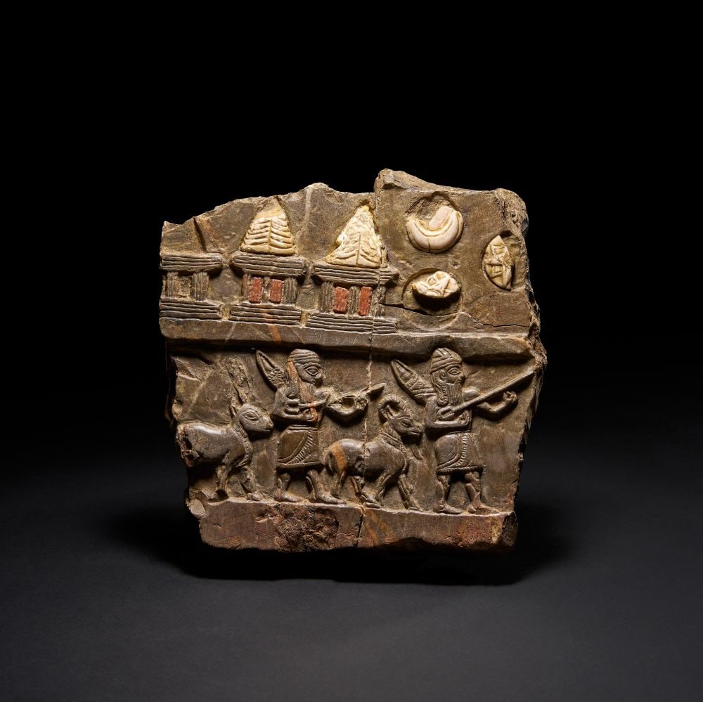 A FIGURAL INLAID GREY STELE PANEL, MESOPOTAMIA, 9TH CENTURY (1 of 3)