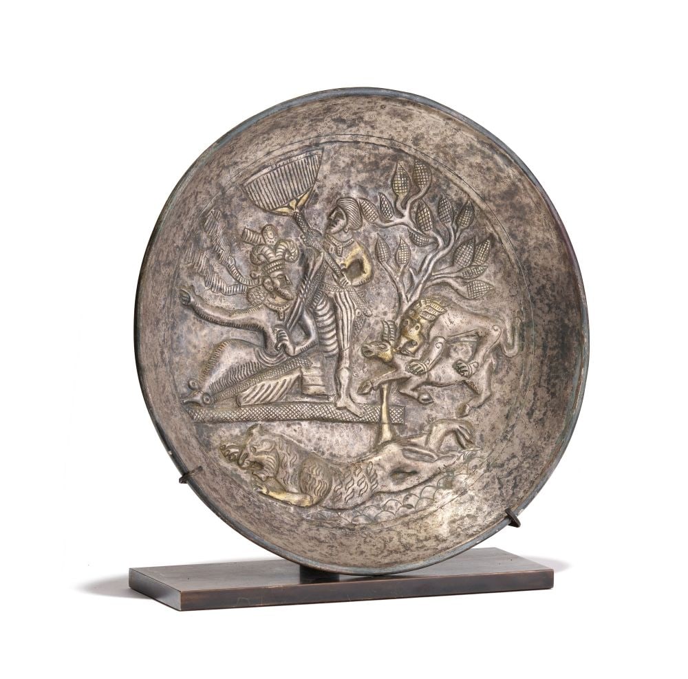 A SASANIAN SILVER & GILT PLATE DEPICTING HUNTING SCENES, CIRCA 4TH-5TH CENTURY B.C.: A SASANIAN SILVER & GILT PLATE DEPICTING HUNTING SCENES, CIRCA 4TH–5TH CENTURY B.C. Finely worked in silver with areas of gilded detail, this circular plate presents a dynamic royal huntin