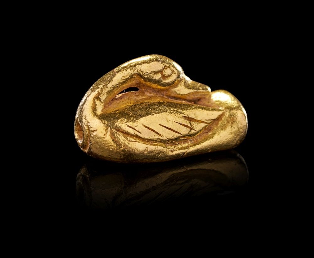 AN EGYPTIAN SOLID GOLD AMULET OF A DUCK OLD KINGDOM, DYNASTY VI, CIRCA 2300-2181 B.C. (1 of 3)