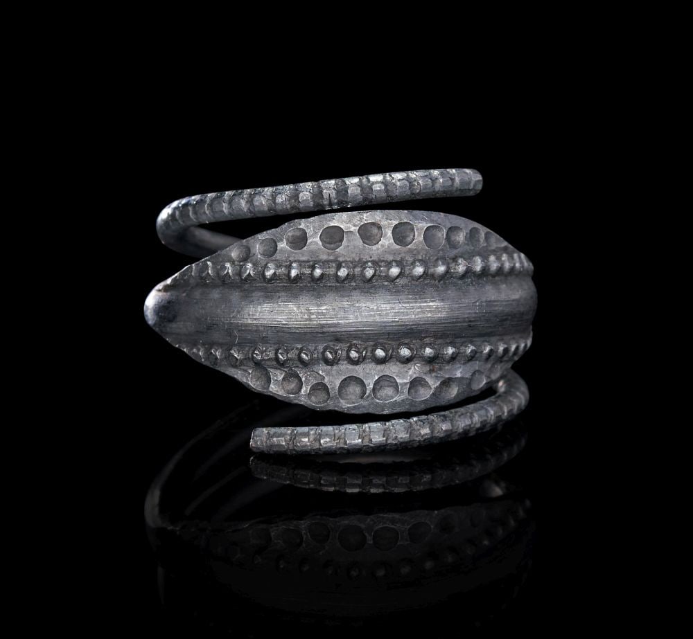 A VIKING SILVER RING, CIRCA 9TH-10TH CENTURY A.D.: A VIKING SILVER SPIRAL RING, CIRCA 9TH–10TH CENTURY A.D. Forged in silver and conceived as a bold spiral form, this ring is composed of a broad, leaf-shaped central plate flanked by twin coile