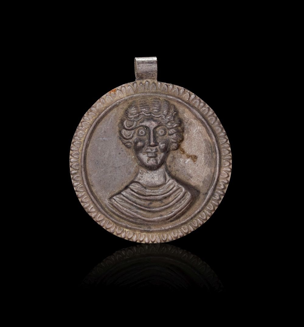 A MEROVINGIAN SILVER MEDALLION LIKELY DEPICTING A BARONESS, CIRCA 5TH-6TH CENTURY A.D. (1 of 2)