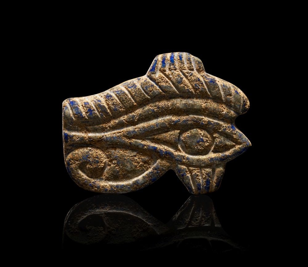 AN EGYPTIAN LAPIS LAZULI WEDJAT-EYE NEW KINGDOM, DYNASTY XIX, CIRCA 1279-1212 B.C. (1 of 2)