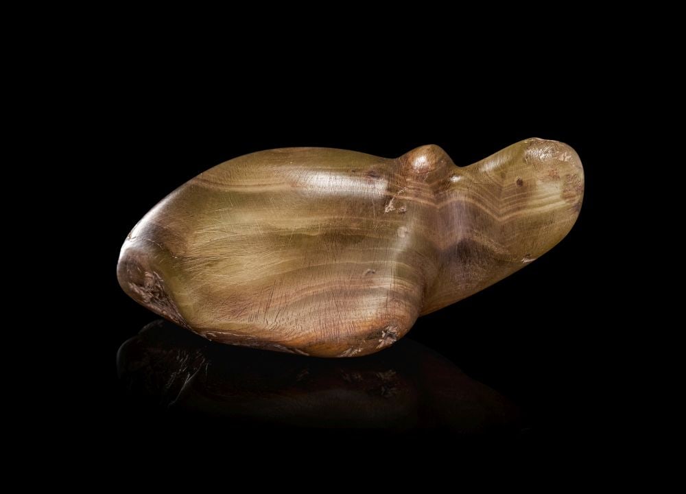 AN EGYPTIAN ALABASTER TORTOISE PREDYNASTIC PERIOD, CIRCA 3200 B.C.: AN EGYPTIAN ALABASTER TORTOISE PREDYNASTIC PERIOD, CIRCA 3200 B.C. Carved in the round from a warm honey-toned alabaster, this compact tortoise is rendered in a softly abstract yet unmistakably natu