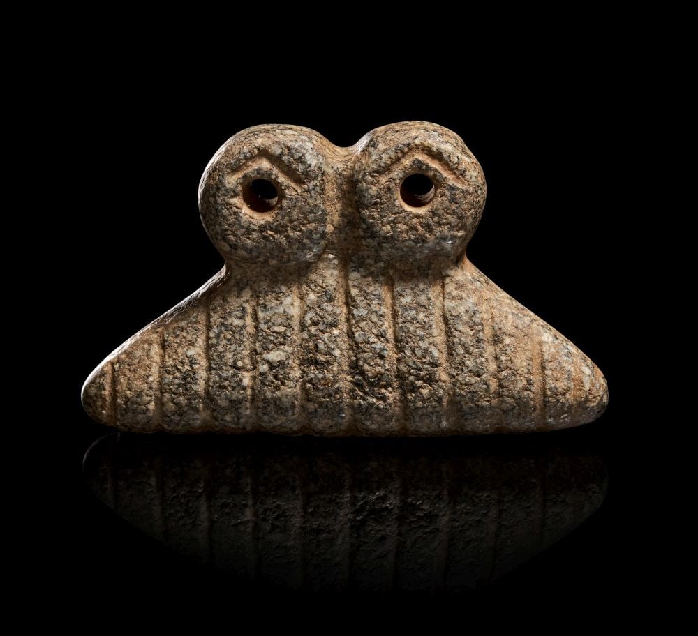 A MESOPOTAMIAN STONE SPECTACLE IDOL, CIRCA 3000 B.C. (1 of 2)