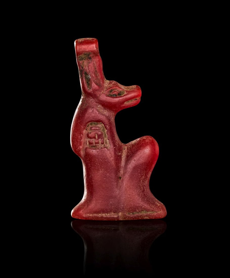 AN EGYPTIAN CARNELIAN ANUBIS AMULET NEW KINGDOM, DYNASTY XIX-XX, 1307-1070 B.C. (1 of 2)