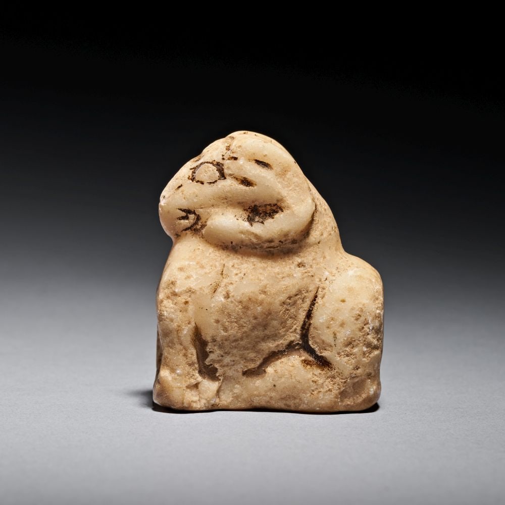 A MESOPOTAMIAN LIMESTONE RECLINING RAM, URUK-JEMDET NASR PERIOD, CIRCA 3300-2900 B.C. (1 of 3)