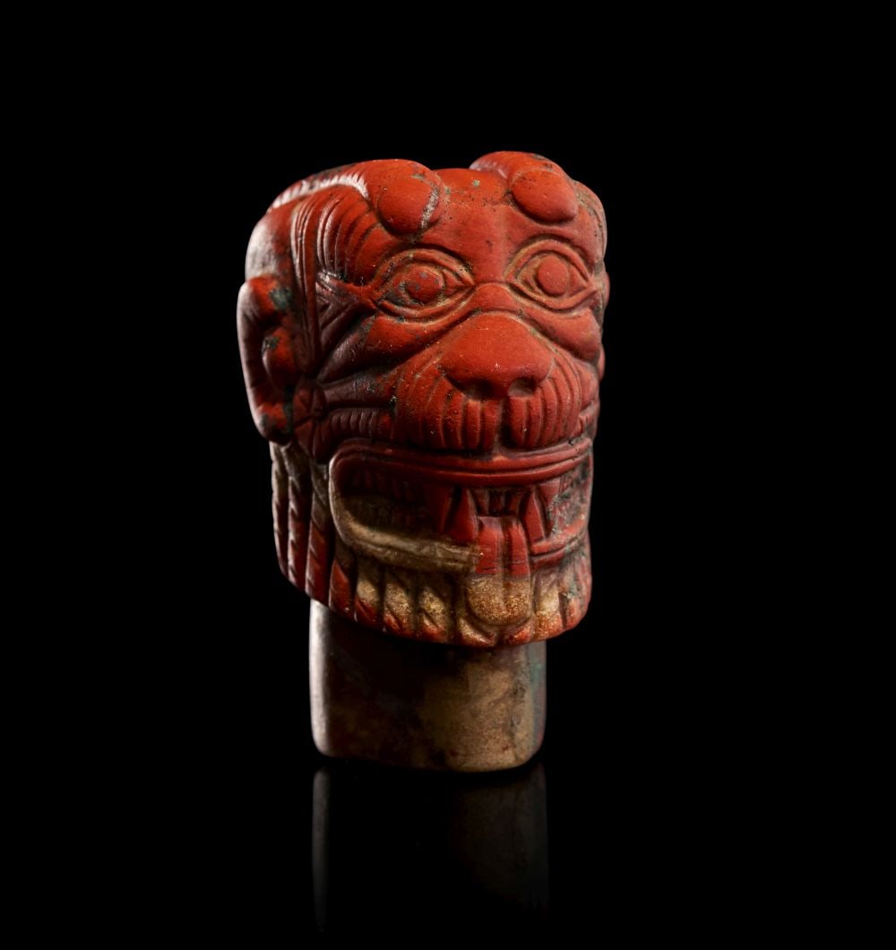 A NEO-ASSYRIAN RED JASPER HEAD OF PAZUZU CIRCA 8TH-7TH CENTURY B.C.: A NEO-ASSYRIAN RED JASPER HEAD OF PAZUZU, CIRCA 8TH–7TH CENTURY B.C. Carved from a richly-hued red jasper of warm, iron-toned translucency, this compact yet forceful head presents the unmistak