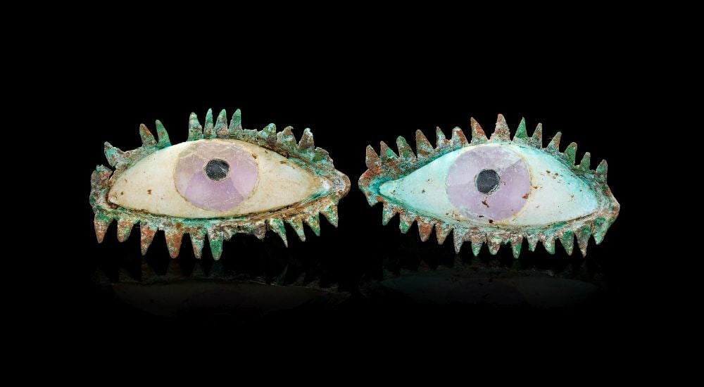 A PAIR OF GREEK BRONZE EYE INLAYS, CLASSICAL PERIOD, CIRCA 5TH CENTURY B.C.E OR LATER: A PAIR OF GREEK BRONZE EYE INLAYS, CLASSICAL PERIOD, CIRCA 5TH CENTURY B.C.E. OR LATER A compelling and unusually evocative pair of bronze eye inlays, each formed as an almond-shaped eye with a fine