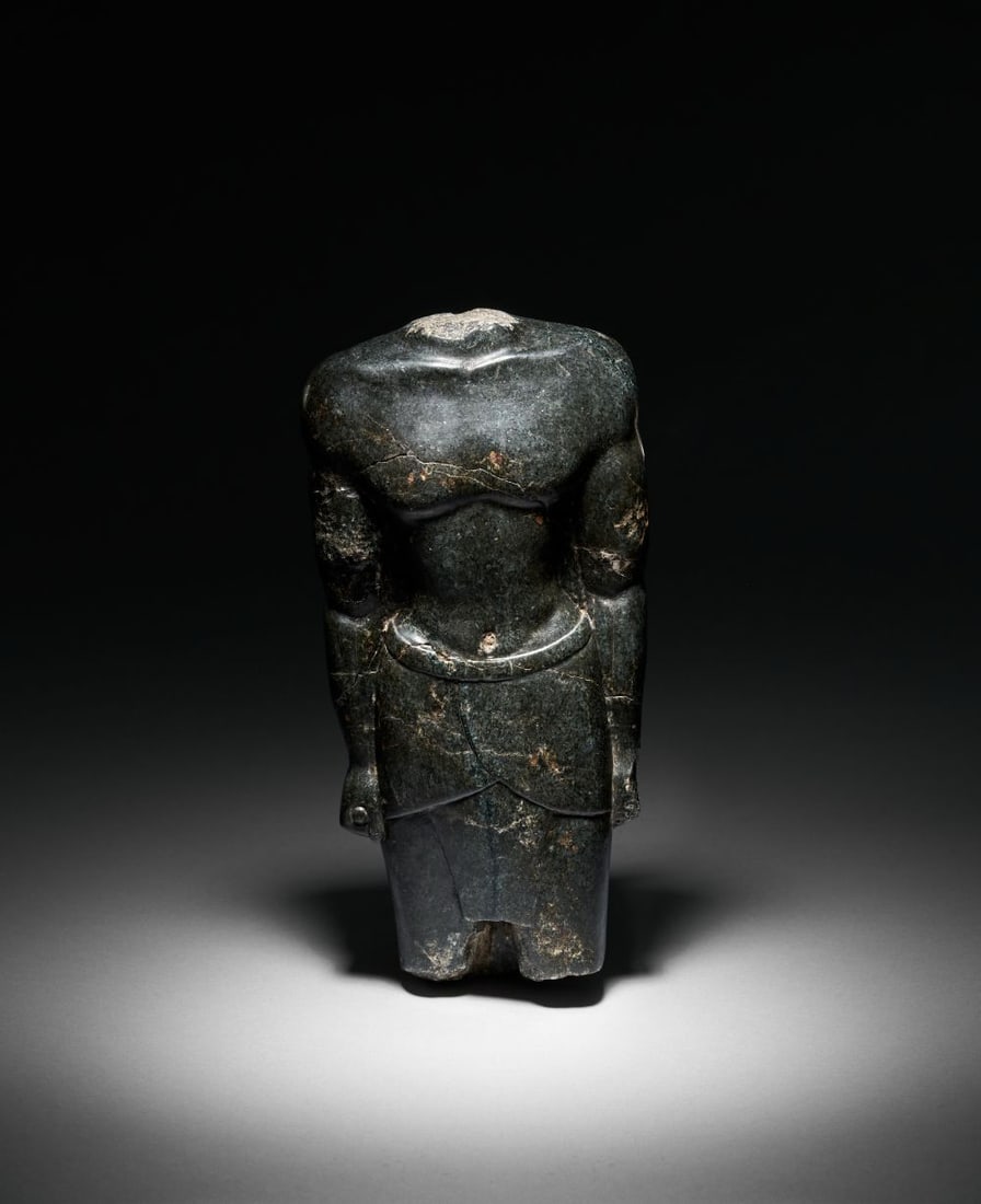 A FRAGMENTARY EGYPTIAN BLACK SERPENTINE FIGURE OF OSIRIS, 26TH DYNASTY, 664-525 B.C.: A FRAGMENTARY EGYPTIAN BLACK SERPENTINE FIGURE OF OSIRIS, 26TH DYNASTY, 664-525 B.C. A finely c