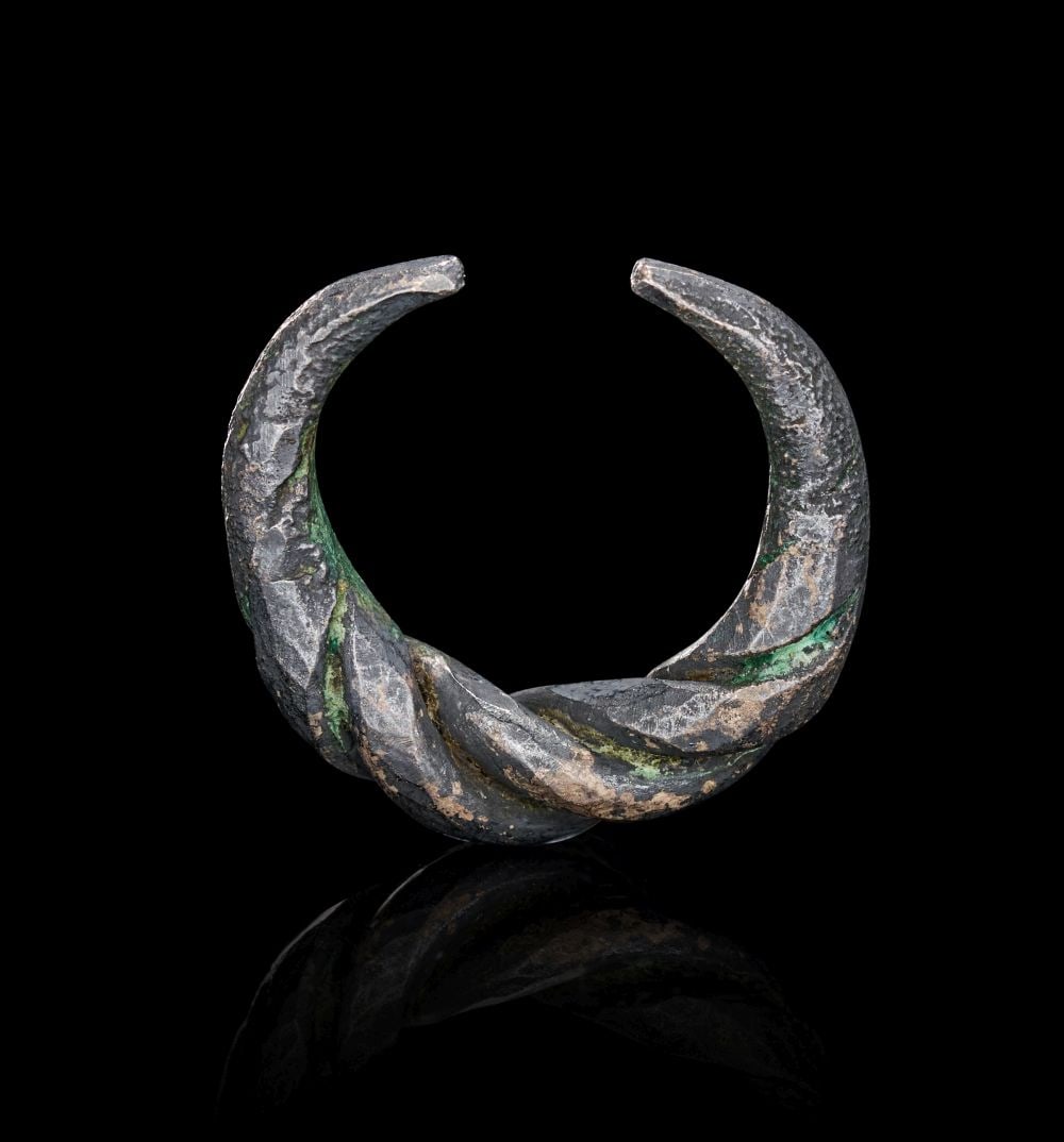 A VIKING SILVER RING, CIRCA 9TH-10TH CENTURY A.D.: A VIKING SILVER TWISTED RING, CIRCA 9TH–10TH CENTURY A.D. Hammered from solid silver and wrought into a bold, open circlet, this ring is formed from two thick rods intricately twisted together