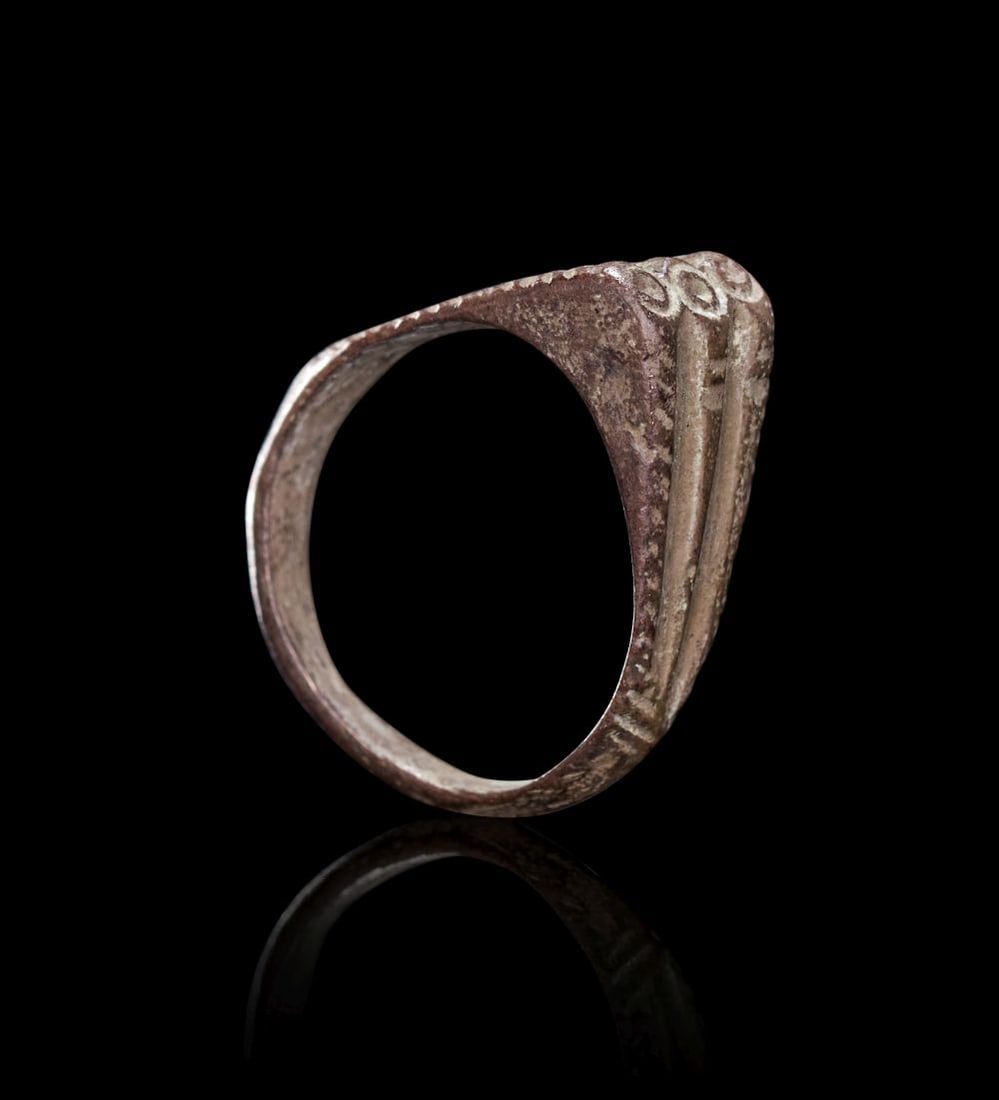 A BRONZE AGE SILVER SIGNET RING CIRCA 1200-600 B.C. (1 of 3)