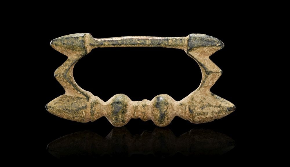 A BRONZE AGE BRONZE BELT BUCKLE CIRCA 1200-600 B.C. (1 of 2)