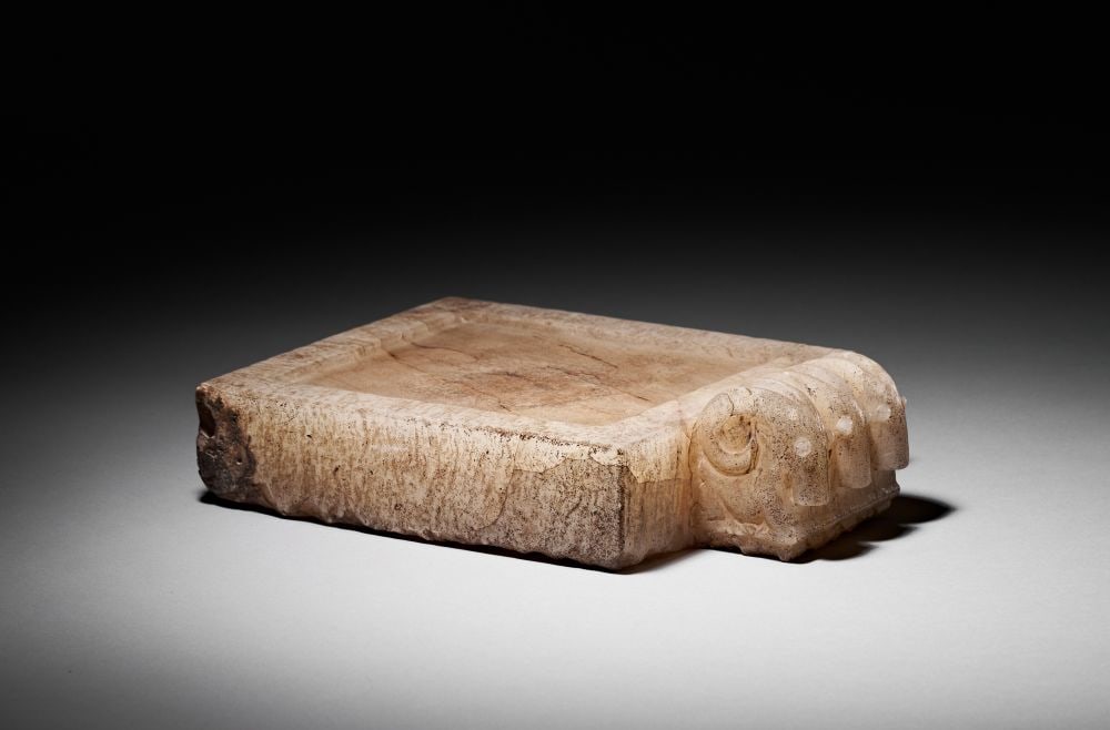 A SOUTH ARABIAN ALABASTER LIBATION TABLE CIRCA 2ND CENTURY B.C.-2ND CENTURY A.D.: A SOUTH ARABIAN ALABASTER LIBATION TABLE CIRCA 2ND CENTURY B.C.-2ND CENTURY A.D. Carved from semi-tra