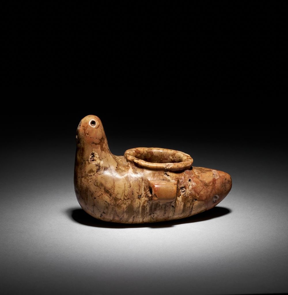 AN EGYPTIAN BRECCIA DUCK JAR, PREDYNASTIC PERIOD, NAQADA II-III, CIRCA 3500-3000 B.C.: AN EGYPTIAN BRECCIA DUCK JAR, PREDYNASTIC PERIOD, NAQADA II-III, CIRCA 3500-3000 B.C. An elegant and