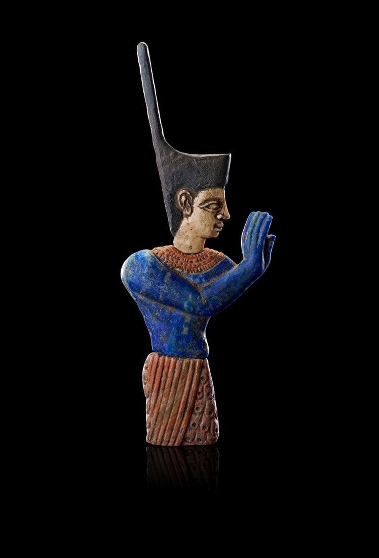 AN EGYPTIAN MULTI INLAY PORTRAIT OF A PHAROH, PTOLEMAIC PERIOD, 304-30 B.C.: A PTOLEMAIC EGYPTIAN POLYCHROME-INLAID FIGURE OF A PHARAOH, CIRCA 304–30 B.C. Carved in the round and conceived with striking vertical emphasis, this finely-modelled figure presents a royal pe