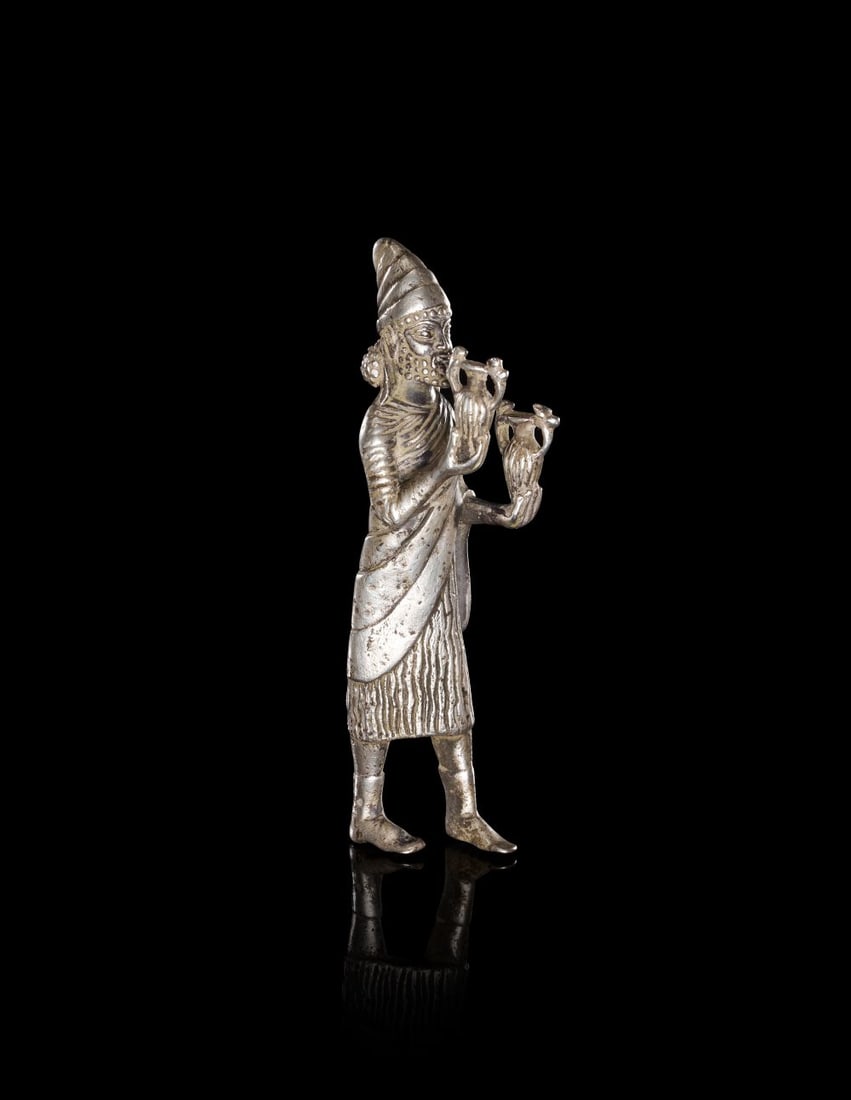 A MESOPOTAMIAN SILVER MALE FIGURE CIRCA LATE 3RD MILLENNIUM B.C. (1 of 3)