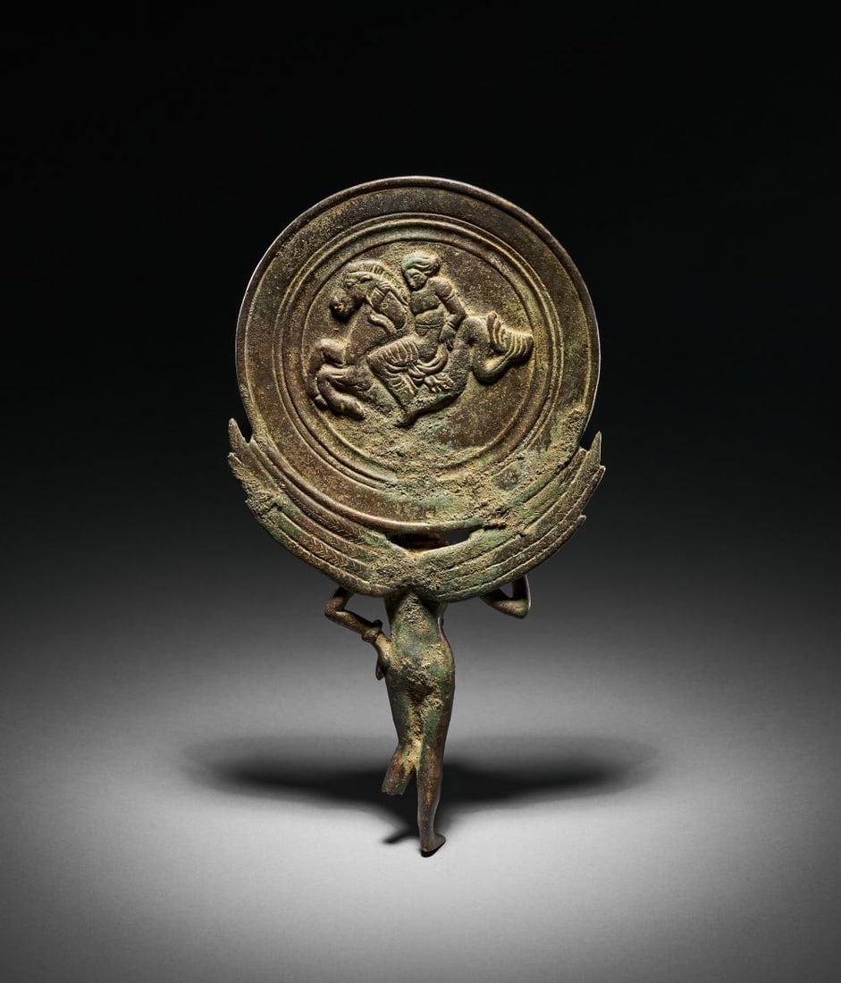 A GREEK BRONZE MIRROR COVER LATE CLASSICAL TO EARLY HELLENISTIC PERIOD, CIRCA 350-300 B.C. (1 of 5)