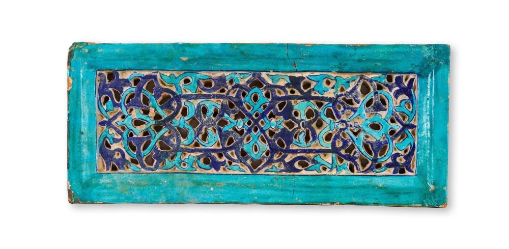 AN ILKHANID CARVED AND GLAZED POTTERY TILE CENTRAL ASIA, SECOND HALF 14TH CENTURY (1 of 2)