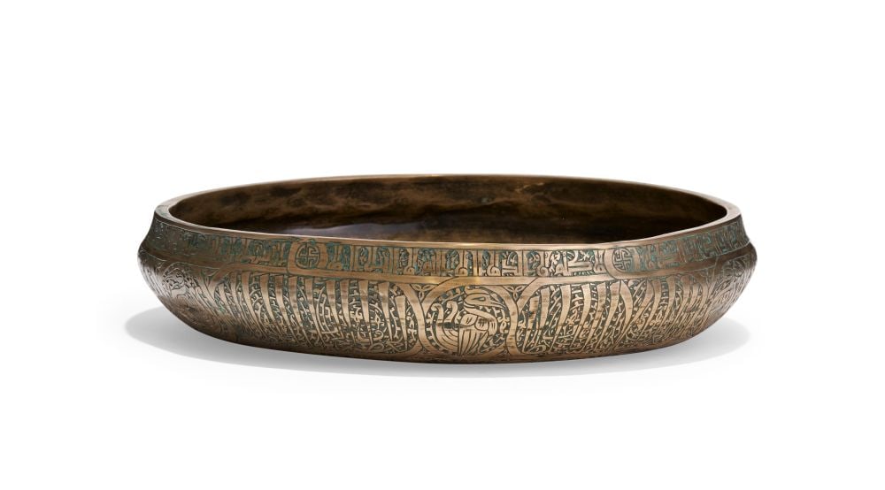 A CALLIGRAPHIC INSCRIBED BRASS BASIN, 19TH CENTURY, QAJAR (1 of 4)