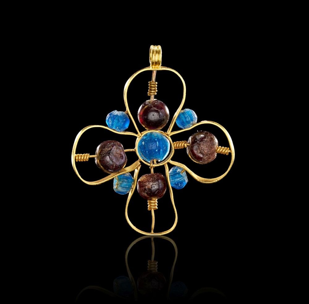 AN UNUSUAL BYZANTINE GOLD & GARNET & AQUAMARINE CROSS, CIRCA 7TH-9TH CENTURY A.D.: AN UNUSUAL BYZANTINE GOLD & GARNET & AQUAMARINE CROSS, CIRCA 7TH-9TH CENTURY A.D. Formed in gold and set with garnet and aquamarine beads, this Byzantine cross pendant has an open, wirework st
