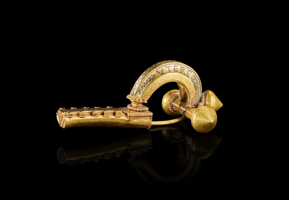 A MAGNIFICENT HIGH KARAT GOLD CROSSBOW FIBULA (BROOCH) LATE ROMAN, 3RD-4TH CENTURY A.D.: A MAGNIFICENT HIGH KARAT GOLD CROSSBOW FIBULA (BROOCH) LATE ROMAN, 3RD-4TH CENTURY A.D. Of monumental ceremonial form, the richly constructed gold fibula composed of an arched bow terminating in