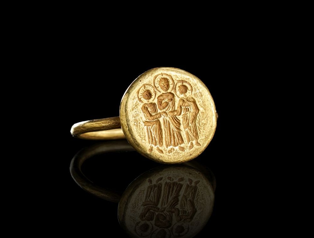A BYZANTINE HIGH KARAT GOLD MARRIAGE RING, EARLY BYZANTINE CIRCA 6TH-7TH CENTURY A.D.: A BYZANTINE HIGH KARAT GOLD MARRIAGE RING, EARLY BYZANTINE CIRCA 6TH-7TH CENTURY A.D. Solid high-karat gold matrimonial ring with oval bezel engraved in relief with the traditional Christian marriage 
