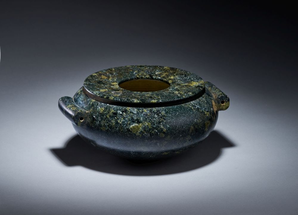 A MONUMENTAL EGYPTIAN GRANODIORITE JAR PREDYNASTIC PERIOD, NAQADA I-II, CIRCA 4000-3200 B.C.: A MONUMENTAL EGYPTIAN GRANODIORITE JAR PREDYNASTIC PERIOD, NAQADA I-II, CIRCA 4000-3200 B.C. Carved from dark, mottled granodiorite, this monumental Egyptian jar has a broad, low body with a rounded p