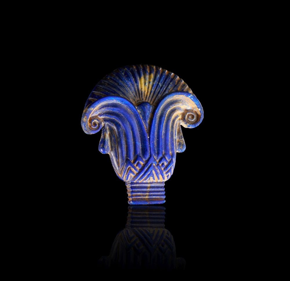 AN ANCIENT EGYPTO-PHOENICIAN LAPIS LAZULI LOTUS-PALMETTE INLAY, CIRCA 1000-600 B.C.E.: AN ANCIENT EGYPTO-PHOENICIAN LAPIS LAZULI LOTUS-PALMETTE INLAY, CIRCA 1000-600 B.C.E. A finely carved lapis lazuli inlay of stylized lotus-palmette form, rendered in high relief with elegant radiating