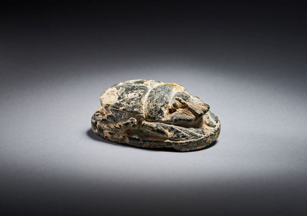 AN EGYPTIAN BLACK SERPENTINE HEART SCARAB FOR RAMOSE NEW KINGDOM, DYNASTY XVIII-XX, CIRCA 1550-1069: AN EGYPTIAN BLACK SERPENTINE HEART SCARAB FOR RAMOSE, NEW KINGDOM, DYNASTY XVIII–XX, CIRCA 1550–1069 B.C. Carved from black serpentine, this Egyptian heart scarab has a compact oval form, 