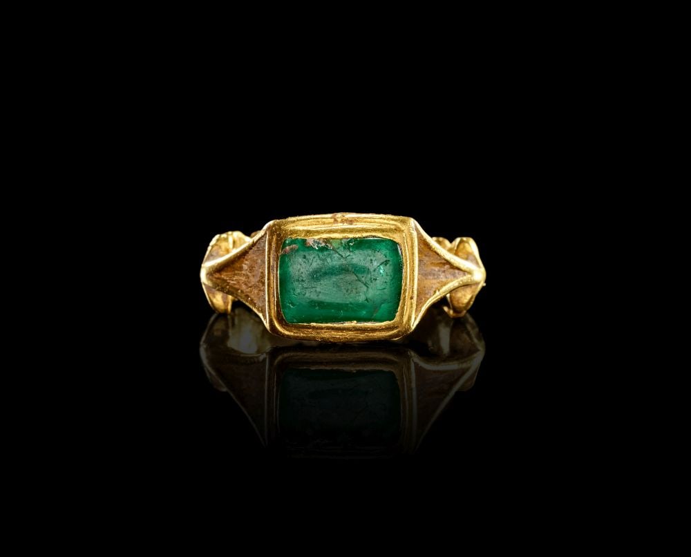 A RARE ROMAN GOLD & EMERALD RING, CIRCA 1ST-2ND CENTURY A.D.: A RARE ROMAN GOLD & EMERALD RING, CIRCA 1ST–2ND CENTURY A.D. A Roman gold ring set with a rectangular emerald, dating to circa 1st–2nd century A.D. The ring is formed with a broad hoop