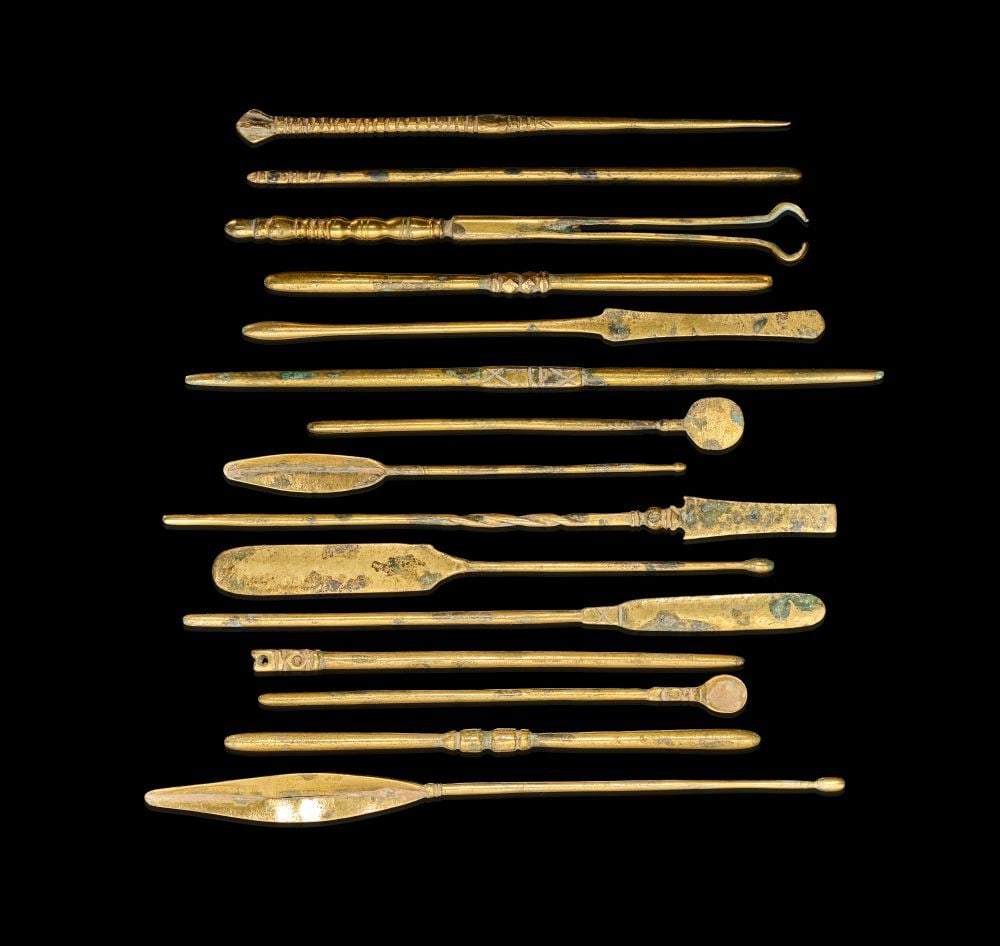 A GROUP OF FIFTEEN ROMAN GILDED BRONZE INSTRUMENTS, ROMAN EMPIRE, CIRCA 1ST–3RD CENTURY A.D.: A GROUP OF FIFTEEN ROMAN GILDED BRONZE INSTRUMENTS, ROMAN EMPIRE, CIRCA 1ST–3RD CENTURY A.D. This finely preserved group of fifteen Roman gilded bronze instruments dates to the height of the Rom