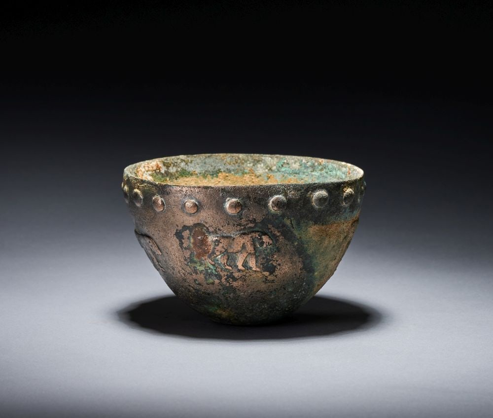 A RARE SUMERIAN OR ELAMITE BRONZE BOWL WITH A PROCESSION OF ANIMAL, EARLY 3RD MILLENNIUM B.C.: A RARE SUMERIAN OR ELAMITE BRONZE BOWL WITH A PROCESSION OF ANIMAL, EARLY 3RD MILLENNIUM B.C. A rare Sumerian or Elamite bronze bowl, early 3rd millennium B.C., of deep rounded form with a slightly fl
