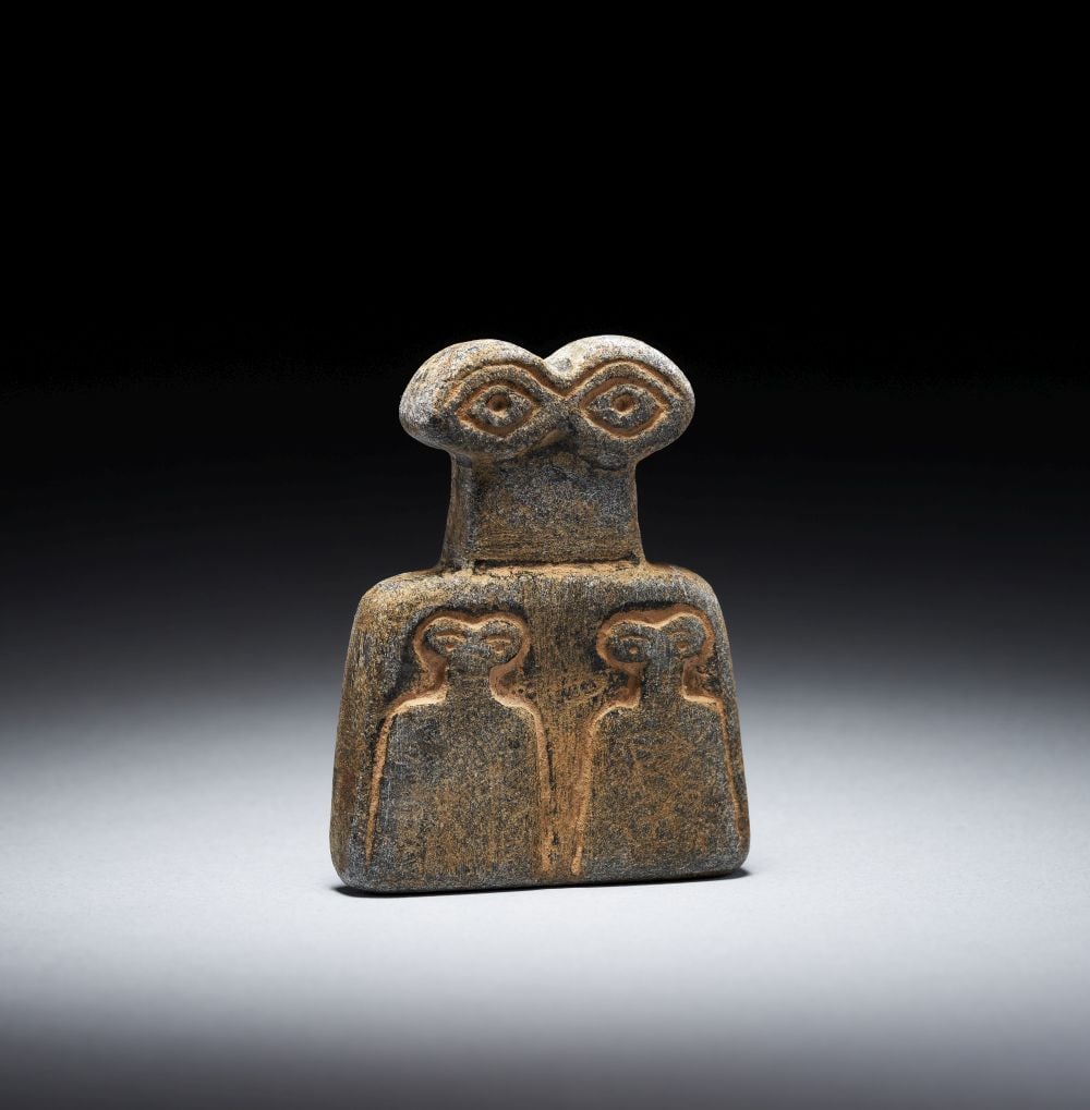 A MARBLE "EYE" IDOL TELL BRAK REGION, CIRCA 3500-3300 B.C.: A MARBLE "EYE" IDOL TELL BRAK REGION, CIRCA 3500-3300 B.C. A marble “eye” idol from the Tell Brak region, ci