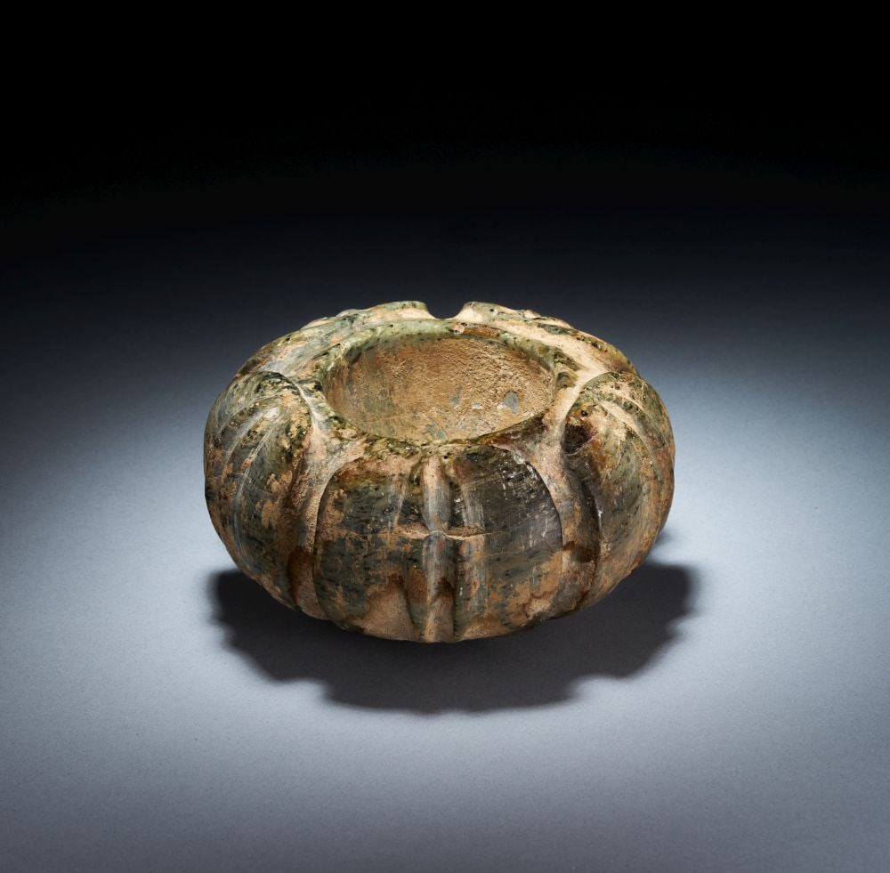 A MINOAN SERPENTINE BLOSSOM BOWL MIDDLE MINOAN III-LATE MINOAN I, CIRCA 1750-1450 B.C.: A MINOAN SERPENTINE BLOSSOM BOWL MIDDLE MINOAN III-LATE MINOAN I, CIRCA 1750-1450 B.C. A Minoan serpentine blossom bowl, Middle Minoan III-Late Minoan I, circa 1750-1450 B.C. Carved from mottled green